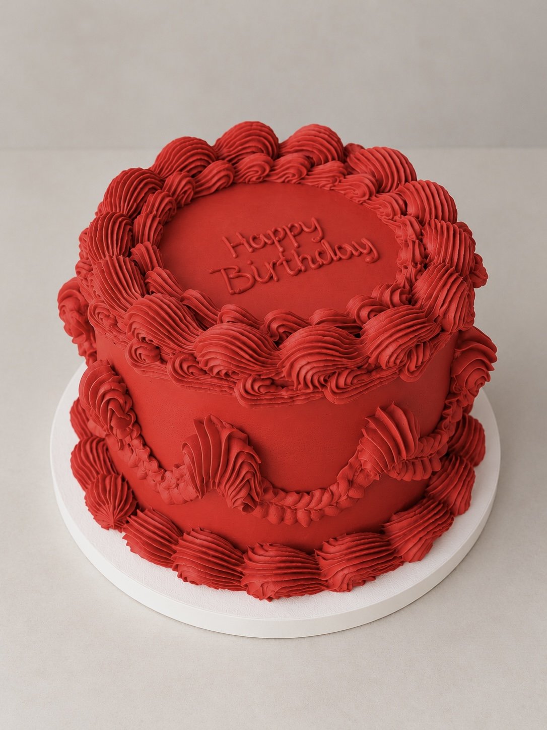 Red heart-shaped cake with piped cream